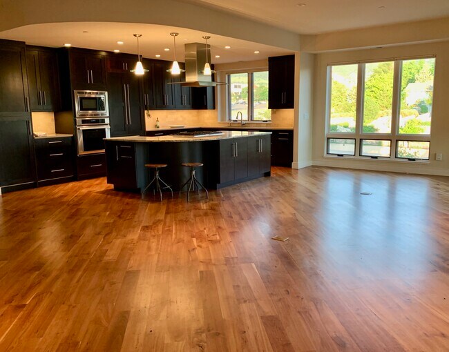 Across living room floor into kitchen. - 2801 Pennsylvania Ave