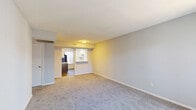 Located at 1515 Wilson Rd in Conroe, TX, this single-story home offers a practical and functional layout across three bedrooms and two bathrooms. The combined kitchen and living room serves as the central hub of the home, with the living area featuring neutral gray carpet, clean white walls, and an open sightline into the kitchen. The kitchen is outfitted with two-tone cabinetry — white upper cabinets and gray lower cabinets — paired with light countertops, a stainless steel double-basin sink, a black dishwasher, and wood-look vinyl flooring. A window provides natural light to the space. The bedrooms are carpeted and finished with neutral tones, offering a calm and understated atmosphere. The primary bedroom provides a comfortable amount of space, while the additional bedrooms are well-proportioned and include closet access with double-door closets. Ceiling fans are present in the bedrooms for added comfort. The bathrooms feature textured walls, vanity mirrors, and clean fixtures. Two dedicated closets offer practical storage throughout the home. Overall, the layout is efficient and straightforward, making it a functional residence in the Conroe area.