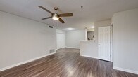 Located at 1500 Brandon Glen Way NE in Conyers, GA, this 2-bedroom, 1-bathroom residence offers a well-organized single-floor layout designed for comfortable everyday living. The open-concept living room is finished with durable wood-look plank flooring and features a ceiling fan with light fixture, neutral gray walls, and a sliding glass door that invites natural light into the space. Built-in closet storage and a textured ceiling complete the living area's functional design.

The galley-style kitchen is a standout feature, showcasing gray shaker cabinetry, marble-look countertops, a subway tile backsplash, and a full suite of stainless steel appliances including a refrigerator, electric range, dishwasher, and range hood. A peninsula counter connects the kitchen to the living area, creating a convenient pass-through layout.

Both bedrooms are carpeted for comfort and feature neutral tones, textured ceilings, and windows that bring in natural light. The primary bedroom includes a dedicated closet for storage. The full bathroom is appointed with a gray vanity cabinet, marble-look countertop, a wall-mounted mirror, and a shower-tub combination, all set on wood-look flooring for a cohesive finish throughout the home.