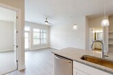Located at 200 Travis Dr in McDonough, GA, this well-appointed 2-bedroom, 2-bathroom single-story home offers a thoughtfully designed open-concept layout. Light wood-look flooring flows throughout the main living areas, complemented by neutral wall tones and clean white trim that create a bright, welcoming atmosphere. The living room is bathed in natural light from large windows and a glass door leading to an outdoor area, and is finished with a ceiling fan for year-round comfort. The dining area connects seamlessly to the kitchen, which features granite countertops, white shaker-style cabinetry, stainless steel appliances including a side-by-side refrigerator and dishwasher, a peninsula with a sink and pendant lighting, and a pantry for added storage. Both bedrooms are carpeted and equipped with ceiling fans; the primary bedroom is generously sized and includes a well-appointed en-suite bathroom with granite vanity, white cabinetry, and direct access to a spacious walk-in closet with built-in wire shelving. The second bedroom offers pleasant outdoor views. Additional highlights include five closets total, a dedicated laundry area, a utility room, and a hallway connecting all rooms efficiently. The home presents a clean, modern aesthetic throughout.