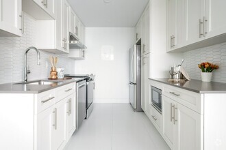 Galley kitchen layout with four stainless steel appliances - Le 4300