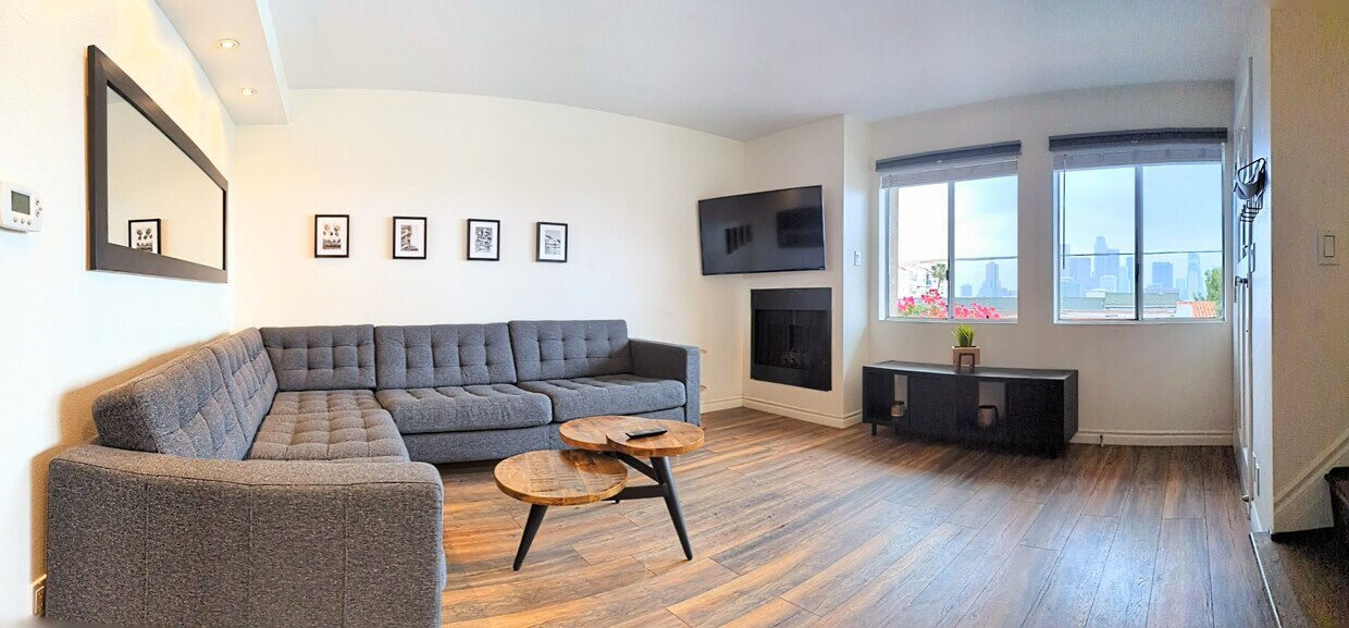 Living Room with Spacious Modular Couch, TV, Fireplace, Home Cocktail Bar, Mini-Fridge, and Iconic D - 995 Figueroa Ter