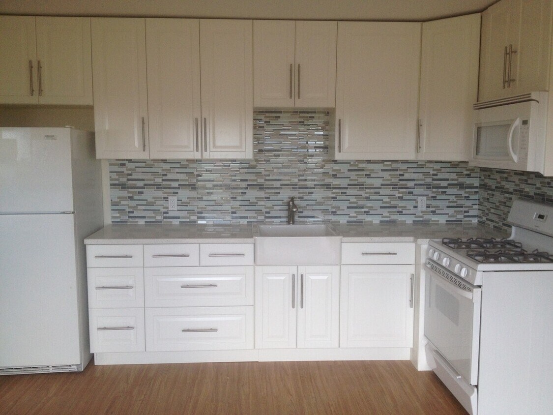 Galley kitchen with quartz countertops, apron sink - 5937 Mildred St