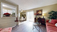This well-appointed one-bedroom, one-bathroom unit in Wichita, Kansas offers a thoughtfully organized single-floor layout that maximizes its compact footprint. The living room features rich, dark hardwood-style flooring, neutral warm-toned walls, and ample space for comfortable seating, with direct sightlines to the hallway and entry door. A ceiling fan overhead adds both function and character.

The adjoining dining area transitions to lighter tile flooring and benefits from abundant natural light streaming through a full sliding glass door fitted with vertical blinds. A mirrored wall visually expands the dining space, enhancing its open feel. The kitchen runs along a galley-style corridor with white cabinetry, laminate countertops, tile flooring, and standard appliances including a range, dishwasher, and refrigerator.

The spacious primary bedroom is carpeted and includes a dedicated walk-in closet, a textured ceiling, and a window allowing natural light. The full bathroom features tile flooring, a single-sink vanity with dark countertops and ample cabinet storage, and a tub-shower combination with tiled surround. A connecting hallway ties all rooms together efficiently.