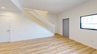 This contemporary townhouse in Homestead, Florida, offers a well-designed living space across two floors, totaling 1160 square feet. The property features three bedrooms and three bathrooms, with a generously sized primary bedroom of 180 square feet. The ground floor spans 590 square feet, while the upper level measures 570 square feet.

The interior showcases a modern aesthetic with clean lines and a neutral color palette. Light-toned wood flooring runs throughout, creating a seamless flow between spaces. The open-concept kitchen is a highlight, boasting sleek light wood cabinetry, stainless steel appliances, and a functional L-shaped layout. White countertops and a subway tile backsplash complete the contemporary look.

Bedrooms are bright and airy, with large windows allowing natural light to flood the spaces. Built-in closets provide ample storage. The bathrooms feature modern fixtures, including a combination of wooden vanities and white countertops. A bathtub-shower combo with gleaming white tiles offers a spa-like atmosphere.

The property also includes a small outdoor area with artificial turf, perfect for low-maintenance relaxation. The exterior showcases a modern multi-unit complex design, indicating a vibrant community setting. With its thoughtful layout and contemporary finishes, this townhouse presents an attractive option for comfortable family living or as an investment property in the growing Homestead area.