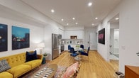 Located at 269 S Mariposa Ave in Los Angeles, this single-story residence offers a thoughtfully designed open-concept layout with warm hardwood flooring flowing throughout the main living areas. The living and dining spaces are seamlessly connected, bathed in light from recessed ceiling fixtures and a sliding glass door that opens to an outdoor area, creating an inviting and airy atmosphere.

The contemporary kitchen is outfitted with high-gloss white cabinetry extending to the ceiling, a subway tile backsplash, white quartz countertops, and a full suite of stainless steel appliances including a refrigerator, range, microwave, and dishwasher. A stacked in-unit washer and dryer is conveniently tucked nearby.

The bedroom is a calm retreat featuring a large window with views of greenery, a walk-in closet with built-in shelving, and clean white walls. The bathroom features a tub-shower combination enclosed by a glass panel, white subway tile surround with a built-in niche, penny tile flooring, and a modern vanity with ample mirror space. Crisp white walls and recessed lighting throughout give the entire space a clean, modern aesthetic well-suited to Los Angeles living.