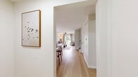 Located at 5842 Firethorne Drive in Toledo, Ohio, this two-story home offers a thoughtfully designed layout spread evenly across two floors. The main level features an open-plan kitchen and living room bathed in natural light from multiple windows. The kitchen is appointed with two-tone cabinetry — warm natural wood lower cabinets paired with crisp white upper cabinets — complemented by a classic subway tile backsplash, a stainless steel dishwasher, and matte black hardware throughout. Light hardwood-style flooring flows seamlessly into the living and dining areas, where a ceiling fan adds comfort. A compact, bright dining nook with garden views sits adjacent to the main living space. One bathroom on the main level features a wood-toned vanity with a white countertop and matte black accents. The upper level hosts three bedrooms, including a spacious primary bedroom with vaulted ceilings, a ceiling fan, and natural light. The two additional bedrooms are comfortably sized with plush carpet flooring and window views of greenery. The second full bathroom features a shower-tub combination with a curved curtain rod and light hardwood-style flooring. A utility room, dedicated closet, and two hallways complete the functional floor plan of this clean, modern home.