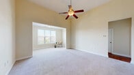 Located at 5001 Ballantyne Drive in Simpsonville, SC, this well-designed single-story home offers three bedrooms, three full bathrooms, and a thoughtful layout that maximizes comfort and functionality. The interior features a pleasing combination of warm hardwood-style flooring in the main living areas and rich-toned wood floors in the bathrooms, while plush carpeting adds warmth to the bedrooms and living spaces. The kitchen is equipped with rich wood cabinetry, granite-style countertops, a full suite of black appliances including a refrigerator and range, and direct access to a dedicated laundry room complete with washer and dryer hookups and built-in shelving. Two separate living areas provide flexible space for entertaining or relaxing. The primary bedroom is generously sized, featuring vaulted ceilings, a ceiling fan, and a bright bay-style window nook that fills the room with natural light. Additional bedrooms are well-lit with multiple windows offering pleasant outdoor views. The three bathrooms are each finished with tub-shower combinations and warm wood-tone flooring. Crown molding and chair rail detailing in the entry area add a refined touch, while three closets provide ample storage throughout the home.