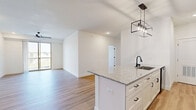 This thoughtfully designed 3-bedroom, 1-bathroom home in Nixa, Missouri offers a clean, modern aesthetic throughout its single floor. Light-toned hardwood-style flooring runs seamlessly through every room, complementing the crisp white walls and creating a bright, cohesive atmosphere.

The open-concept kitchen and living area serves as the heart of the home. The kitchen is outfitted with white shaker cabinets featuring black hardware, a granite-topped island with an undermount sink, subway tile backsplash, stainless and black appliances, and stylish pendant lighting — combining both function and contemporary style. The adjoining living room is generously sized with a ceiling fan and a sliding glass door that opens to a private balcony, bringing in abundant natural light and outdoor views of the surrounding neighborhood.

The primary bedroom is a comfortable retreat, also featuring a ceiling fan and a sliding glass door to the balcony. The two additional bedrooms are well-proportioned with clean white walls and ample natural light. A dedicated walk-in closet with wire shelving provides organized storage.

The full bathroom is finished with a tub/shower combination and modern fixtures. A dedicated laundry room houses a full-size side-by-side washer and dryer with overhead wire shelving, adding everyday convenience to this move-in-ready home.