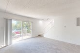 Located at 333 Lancaster Avenue in Malvern, PA, this two-story home offers three bedrooms and three bathrooms across two evenly divided floors, providing a well-balanced and functional layout. The main floor features a welcoming entrance that flows into a spacious living room, highlighted by large sliding glass doors that invite natural light and provide views of the surrounding greenery. A staircase with a railed balustrade connects the two levels seamlessly. The kitchen has been tastefully updated with light grey shaker-style cabinetry, brushed nickel hardware, white quartz countertops, a subway tile backsplash, and stainless steel appliances, all set atop light hardwood-style flooring. A pantry and adjacent dining room complete the main-floor living space, along with a convenient laundry area. Upstairs, the primary bedroom is generously sized, carpeted, and filled with natural light from a window overlooking the outdoors. Two additional bedrooms provide comfortable accommodations, each with plush carpet and closet access. The three bathrooms are clean and functional — one features a tiled walk-in shower, another offers a full tub-shower combo, and a third is finished with dark tile flooring. Six closets distributed throughout the home ensure ample storage at every turn.