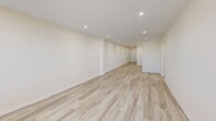 Located at 854-860 E Broadway in Long Beach, NY, this well-appointed 2-bedroom, 2-bathroom unit offers a thoughtfully designed single-floor layout with generous living space throughout. Light wood-tone flooring flows seamlessly across the main living areas and bedrooms, creating a clean and cohesive aesthetic complemented by warm neutral wall tones and recessed lighting.

The kitchen is well-equipped with warm wood cabinetry, granite countertops, a stainless steel dishwasher, and a full suite of appliances including a gas range and refrigerator. It opens directly into the living room, which is bathed in natural light through large windows and features a radiator unit for comfortable climate control.

The spacious primary bedroom includes a closet and recessed lighting, while the second bedroom also offers ample room and closet storage. Both bedrooms continue the light flooring found throughout the unit.

Both bathrooms are elegantly finished with floor-to-ceiling marble-style tile, white vanities with mirrored medicine cabinets, and sliding glass shower enclosures with tub combinations, giving each a clean and polished look.

Hallways connect the layout efficiently, and an additional closet provides extra storage. The unit combines functional design with tasteful finishes, making it a comfortable and attractive residence in Long Beach.