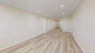 Located at 854-860 E Broadway in Long Beach, NY, this well-appointed 2-bedroom, 2-bathroom unit offers a thoughtfully designed single-floor layout with generous living space throughout. Light wood-tone flooring flows seamlessly across the main living areas and bedrooms, creating a clean and cohesive aesthetic complemented by warm neutral wall tones and recessed lighting.

The kitchen is well-equipped with warm wood cabinetry, granite countertops, a stainless steel dishwasher, and a full suite of appliances including a gas range and refrigerator. It opens directly into the living room, which is bathed in natural light through large windows and features a radiator unit for comfortable climate control.

The spacious primary bedroom includes a closet and recessed lighting, while the second bedroom also offers ample room and closet storage. Both bedrooms continue the light flooring found throughout the unit.

Both bathrooms are elegantly finished with floor-to-ceiling marble-style tile, white vanities with mirrored medicine cabinets, and sliding glass shower enclosures with tub combinations, giving each a clean and polished look.

Hallways connect the layout efficiently, and an additional closet provides extra storage. The unit combines functional design with tasteful finishes, making it a comfortable and attractive residence in Long Beach.