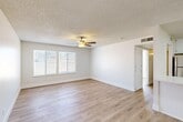 Located at 3505 W Campus Ave in Visalia, CA, this 2-bedroom, 1-bathroom single-floor unit offers a clean, modern aesthetic throughout. The combined living and dining area is bright and open, featuring light wood-style flooring, crisp white walls, a textured ceiling, and a ceiling fan that adds both style and functionality. A large window invites abundant natural light, enhancing the airy feel of the space. The kitchen is thoughtfully designed with white cabinetry, light quartz-style countertops, a peninsula breakfast bar, and stainless steel appliances including a gas range with a sleek overhead hood, dishwasher, and refrigerator. White tile flooring completes the kitchen's clean look. The primary bedroom is generously sized and includes a ceiling fan, while the second bedroom features a window with outdoor views and ample natural light. Both bedrooms are served by light wood-style flooring. Three closets provide substantial storage throughout the unit. The full bathroom is well-appointed with a tub-shower combo, white vanity with undermount sink, and a warm-toned framed mirror. A private balcony offers additional outdoor space, rounding out this well-laid-out and move-in-ready home.