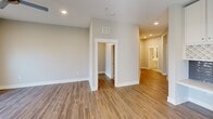 This contemporary apartment in Franklin, TN offers 1450 square feet of well-designed living space. The single-story layout includes five bedrooms, two bathrooms, and an open-concept kitchen and living area. The primary bedroom is generously sized at 220 square feet, providing ample space for relaxation.

The kitchen is a highlight, featuring sleek white cabinetry, stainless steel appliances, and a central island with a sink. Modern pendant lighting and recessed fixtures illuminate the space, while wooden flooring adds warmth throughout. Large windows in the bedrooms and living areas allow for plenty of natural light, enhancing the bright and airy atmosphere.

The bathrooms are equipped with modern fixtures and finishes, including a glass-enclosed shower in one. A separate laundry room adds convenience to daily living. The apartment's neutral color palette and clean lines create a contemporary feel, offering a blank canvas for personal style. Ceiling fans in the bedrooms provide additional comfort.

Located at 4015 Aspen Grove Dr in Franklin, this apartment combines modern amenities with a practical layout, making it an attractive option for those seeking a spacious and stylish living environment.
