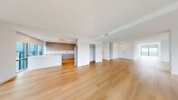 Located at 5000 Brianna Lane in Secaucus, NJ, this sophisticated three-bedroom, four-bathroom residence spans two thoughtfully designed floors. The main level is generously proportioned, anchored by a dramatic great room and living area bathed in natural light from expansive floor-to-ceiling windows that frame sweeping panoramic views of the surrounding landscape. Light-toned hardwood flooring flows seamlessly throughout, enhancing the bright, airy atmosphere. The open-concept kitchen features warm taupe cabinetry, recessed lighting, and stainless steel appliances, connecting effortlessly to the dining and living spaces. A hallway leads to well-organized closets and convenient in-unit laundry equipped with a full-size washer and dryer. The upper level houses the three bedrooms, including a spacious primary suite with an en-suite bathroom. The four bathrooms are finished in a clean, modern style with light wood cabinetry, large-format tile flooring, and a mix of soaking tub and glass-enclosed shower configurations. Additional highlights include ample closet storage with built-in wire shelving systems. The residence offers a refined, contemporary aesthetic throughout, defined by clean lines, neutral tones, and an abundance of natural light.