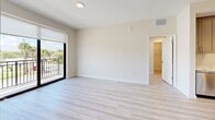 Located at 8300 Cleary Blvd in Plantation, FL, this well-appointed 2-bedroom, 3-bathroom residence offers a thoughtfully designed open-concept layout with modern finishes throughout. The combined kitchen and living area serves as the heart of the home, showcasing gray shaker cabinetry, a classic subway tile backsplash, stainless steel appliances, and a striking quartz-topped island illuminated by elegant pendant lighting. Light wood-style flooring flows seamlessly throughout, enhancing the bright, airy atmosphere. The living area extends naturally toward a private balcony equipped with a sleek metal railing, offering pleasant outdoor views of the landscaped surroundings. The generously sized primary bedroom features direct balcony access, a walk-in closet, and an en suite bathroom complete with a glass-enclosed tile shower, quartz vanity countertop, and gray cabinetry. The second bedroom is equally well-lit, benefiting from a large window with natural light. Six total closets provide abundant storage throughout. The bathrooms maintain a consistent modern aesthetic with quality tile work and refined fixtures. A dedicated laundry area adds everyday convenience, rounding out this clean, contemporary residence.