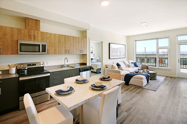 Experience coastal living in style with this open-concept space featuring ocean views and modern finishes. - Waterfront Place