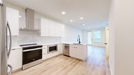 This thoughtfully designed studio in Round Rock, Texas, offers a bright and modern living experience within a well-utilized single-floor layout. The open-plan kitchen and living area forms the heart of the space, anchored by a sleek kitchen featuring flat-front white cabinetry, a marble-look tile backsplash, white quartz countertops, and a peninsula with an undermount sink and matte black faucet. Stainless steel appliances — including a refrigerator, dishwasher, built-in microwave, and electric range — complete the functional yet stylish kitchen. Recessed lighting illuminates the space throughout. Light wood-tone luxury vinyl plank flooring runs seamlessly across the entire unit, enhancing the sense of openness and continuity. The living area is bathed in natural light from multiple large windows and a glass-panel door, with a ceiling fan adding comfort. A closet provides convenient storage. The bathroom is finished with large-format neutral tile surrounding a soaking tub and shower, complemented by matte black fixtures that echo the design language found throughout the unit. Clean white walls and a cohesive modern aesthetic make this studio a bright, move-in-ready space in Round Rock, TX.