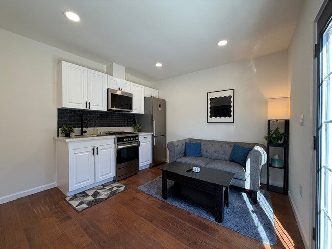 Living Room with brand new SS /Quartz kitchen with gas range - 1518 Warwick Ave