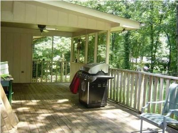 Large back deck has a ceiling fan in the covered portion - 303 Ferncliff Dr