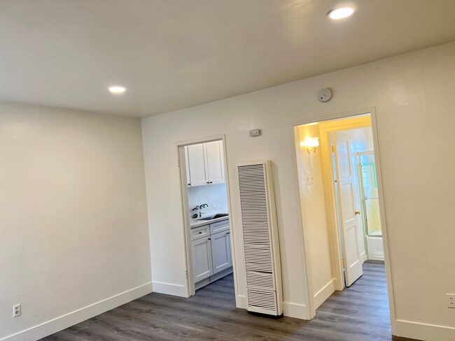S W view at living area, Gas wall heater access to kitchen and bathroom. - 122 Elm Ave