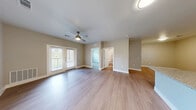 Located at 13411 FM812 in Del Valle, TX, this single-story home offers a thoughtfully designed layout across a comfortable footprint. Light wood-style flooring flows consistently throughout every room, creating a clean and cohesive aesthetic. Neutral warm-gray walls provide a versatile backdrop that complements the modern finishes found throughout the space.

The open-concept kitchen and living area serves as the heart of the home. The kitchen is outfitted with dark espresso cabinetry, granite countertops, subway tile backsplash, stainless steel appliances — including a refrigerator, range, and microwave — and a peninsula with a sink that seamlessly connects to the living area. The living room is generously sized, featuring a ceiling fan with light fixture and access to the outdoors through French doors that invite natural light and outdoor views.

The bedroom offers a comfortable retreat, complete with a ceiling fan, a window with outdoor views, and access to a closet. The bathroom is well-equipped with dark wood cabinetry, granite countertops, a tiled shower/tub combination, and matching flooring that ties the space together. This home presents a modern, move-in-ready living experience with clean finishes and a practical, efficient design.