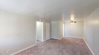 Located at 275 North Ave in Washington, PA, this single-floor unit offers three bedrooms, one bathroom, a kitchen, and a connecting hallway. The layout is straightforward and functional, making efficient use of the available floor space across all rooms. The generous primary bedroom is notably spacious, featuring soft carpeting, neutral-toned walls, a ceiling fan with light fixture, and a closet. The two additional bedrooms are comfortably sized, each with plush carpeting, natural light from windows, and classic radiator heating units — a practical and reliable feature found throughout the home. One of the secondary bedrooms also includes a ceiling fan. The bathroom is clean and utilitarian, equipped with a combined tub and shower, a vanity with sink, a wall-mounted mirror cabinet, and a window that allows natural light. The kitchen features warm wood-toned cabinetry, a gas range, and a full-size refrigerator, with light wood-style flooring that contrasts the carpeted areas elsewhere. Neutral wall colors and consistent carpet flooring throughout the bedrooms and hallway create a cohesive, understated aesthetic. Ceiling fans in multiple rooms and radiator heating reflect a blend of comfort-oriented features suited for year-round living.
