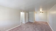 Located at 275 North Ave in Washington, PA, this single-floor unit offers three bedrooms, one bathroom, a kitchen, and a connecting hallway. The layout is straightforward and functional, making efficient use of the available floor space across all rooms. The generous primary bedroom is notably spacious, featuring soft carpeting, neutral-toned walls, a ceiling fan with light fixture, and a closet. The two additional bedrooms are comfortably sized, each with plush carpeting, natural light from windows, and classic radiator heating units — a practical and reliable feature found throughout the home. One of the secondary bedrooms also includes a ceiling fan. The bathroom is clean and utilitarian, equipped with a combined tub and shower, a vanity with sink, a wall-mounted mirror cabinet, and a window that allows natural light. The kitchen features warm wood-toned cabinetry, a gas range, and a full-size refrigerator, with light wood-style flooring that contrasts the carpeted areas elsewhere. Neutral wall colors and consistent carpet flooring throughout the bedrooms and hallway create a cohesive, understated aesthetic. Ceiling fans in multiple rooms and radiator heating reflect a blend of comfort-oriented features suited for year-round living.
