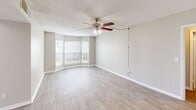 Located at 1910 Honeysuckle Rd in Dothan, Alabama, this 2-bedroom, 3-bathroom residence offers a practical and well-organized single-floor layout. The living room serves as the centerpiece of the home, featuring light wood-style flooring, a ceiling fan with light fixture, a textured ceiling, and a charming bay window that invites natural light and outdoor views. Neutral, warm-toned walls throughout create a clean and consistent aesthetic. Two hallways connect the living areas to the bedrooms and bathrooms, with light wood flooring continuing through these transitional spaces. Each bedroom is carpeted in a neutral beige tone and includes windows with blinds for natural light and privacy. The spacious primary bedroom includes closet access and connects to its own bathroom. The additional bedroom is similarly appointed with plush carpet and ample wall space. The three bathrooms feature tile-style flooring, vanities with white cabinetry and countertops, mirrored medicine cabinets, and well-lit fixtures. A textured ceiling is consistent throughout the home. The kitchen is visible in the floor plan model, offering a functional layout with standard appliances and cabinetry. Overall, the space presents a clean, move-in-ready environment suited for comfortable everyday living.