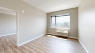 Located at 508 51st Street in West New York, NJ, this well-appointed one-bedroom, one-bathroom residence offers a thoughtfully designed layout across a single floor. The open-plan kitchen and living area serves as the heart of the home, featuring light wood cabinetry, stainless steel appliances including a refrigerator, range, and microwave, a white quartz peninsula countertop with an undermount sink, and elegant pendant lighting overhead. Light wood-look flooring runs throughout, lending warmth and continuity to the space. The bedroom is a comfortable retreat with a neutral color palette, light-filtering windows, a built-in HVAC unit, and sweeping views of the New York City skyline—a standout feature of the residence. A dedicated walk-in closet with wrap-around shelving and hanging rods provides generous storage. The bathroom is finished with large-format tile flooring, a wood-toned vanity with a white countertop, and a full bathtub with subway tile surround and grab bar. Clean lines, neutral tones, and abundant natural light throughout give the space a modern, airy ambiance, while the iconic city views add a distinctive and desirable dimension to everyday living.