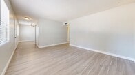 Located at 4235 N 35th Ave in Phoenix, Arizona, this single-floor, three-bedroom, one-bathroom home offers a clean and functional layout with a cohesive neutral design throughout. Light wood-look flooring runs continuously across all rooms, creating a bright and unified feel.

The living room is an open, airy space featuring a ceiling fan with light fixture and a textured ceiling. It flows naturally into the galley-style kitchen, which is equipped with white cabinetry, light countertops, a stainless steel sink, and black appliances including a range and refrigerator. The kitchen offers ample cabinet storage on both sides and is finished with the same light flooring.

The three bedrooms are well-proportioned and share a consistent design: neutral gray-toned walls, light wood-look flooring, textured ceilings, and windows with blinds that allow natural light to filter in. The primary bedroom includes a sliding double-door closet, providing practical storage. Additional bedrooms offer clean, versatile spaces suitable for various uses.

The full bathroom is finished in white, featuring a tub-shower combo, toilet, and a single-sink vanity with modern hardware. The overall ambiance of the home is clean, bright, and move-in ready, with a simple and practical design that suits a wide range of lifestyles.