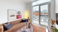 Located at 422 Cherry St in Toronto's vibrant Canary District, this well-appointed 2-bedroom, 2-bathroom residence offers a thoughtfully designed single-floor layout with modern finishes throughout. The open-concept kitchen and living area forms the heart of the home, featuring sleek flat-panel cabinetry, stainless steel appliances, a generous island with bar seating, and a linear pendant light overhead. Light hardwood flooring and crisp white walls create a bright, cohesive aesthetic across the main living space. A dark marble console at the entry adds an elegant, grounding accent upon arrival. The living room benefits from expansive floor-to-ceiling windows that frame views of the Toronto skyline, flooding the space with natural light. The primary bedroom includes a sliding-door closet and its own window with city views, while the second bedroom is a comfortable, well-proportioned retreat. Both bathrooms are finished with striking terrazzo-style stone tiling — one featuring a soaker tub and the other a stand-up shower — paired with light wood vanities and backlit mirrors. The overall ambiance is clean, contemporary, and functional, making this an ideal urban residence in one of Toronto's emerging neighbourhoods.