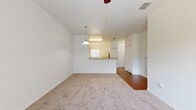 Located at 4714 Crosswind Court in Melbourne, FL, this single-story, one-bedroom, one-bathroom home offers a well-organized and functional layout across a compact but efficiently used floor plan. The open-concept design connects the kitchen and living room seamlessly, creating a comfortable and cohesive living area.

The kitchen is outfitted with warm honey-toned wood cabinetry, a full suite of white appliances including a refrigerator, electric range, built-in microwave, and dishwasher, and a double-basin sink. A peninsula counter provides additional workspace and separates the kitchen from the living area, which features a pendant light and durable wood-style flooring that flows through the kitchen and hallway.

The living room is generously proportioned with plush wall-to-wall carpeting, a ceiling fan, and access to natural light. A pass-through view of the kitchen peninsula adds to the open feel of the space.

The primary bedroom is a well-sized retreat with soft carpeting, a ceiling fan, a large window offering outdoor views of lush greenery, and a sliding glass door with vertical blinds. A closet provides ample storage.

The bathroom features wood-style flooring, a single-sink vanity with light countertops, a toilet, and a full bathtub-shower combination. The clean, neutral palette throughout the home creates a bright and welcoming atmosphere.