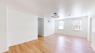 Located on Hust Alley in Cincinnati, OH, this thoughtfully designed single-floor residence offers 3 bedrooms and 2 bathrooms with a clean, modern aesthetic. Light hardwood flooring flows consistently throughout every room, creating a bright and cohesive feel. The open living area is finished with crisp white walls, a contemporary square ceiling light fixture, a wall-mounted mini-split system for climate control, and windows that invite natural light. A bold green front door serves as a striking entryway detail, adding a pop of character to the otherwise minimalist palette. The kitchen is well-appointed with white shaker cabinetry, dark countertops, a classic white subway tile backsplash, and a full suite of stainless steel appliances including a refrigerator, range, microwave, and dishwasher. Each bedroom is bright and cleanly finished, with dedicated wall-mounted climate control units and square pendant lighting. The primary bedroom offers generous proportions with multiple closet access points. The bathrooms feature white subway tile surrounds with glass panel enclosures over soaking tubs. Four closets provide ample storage throughout the home. A central hallway connects all rooms efficiently, contributing to a practical and comfortable layout.