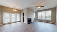 Located at 2752 Gaston Ave in Dallas, TX, this single-story home offers a well-designed, open layout with contemporary finishes throughout. The main living and dining area is bright and welcoming, featuring wood-look flooring, a ceiling fan, chandelier, and a striking tiled fireplace as a central focal point. Large windows with blinds invite abundant natural light, and French doors provide views of the outdoors.

The kitchen is well-equipped with rich, dark espresso cabinetry, granite countertops, a subway tile backsplash, stainless steel appliances, and a center island that adds additional prep and storage space. Wood-look flooring continues throughout, and multiple windows keep the space airy and bright.

The bedrooms are carpeted for comfort, each featuring windows with natural light and ceiling fans where noted. Closet space is provided, including a reach-in closet with built-in shelving. A spacious secondary bedroom offers an additional large window with outdoor views.

The primary bathroom is generously sized with a dual-sink vanity featuring granite countertops, dark cabinetry, a soaking tub, and wood-look flooring. A secondary bathroom mirrors the same refined finishes with a combined tub and shower, granite countertop vanity, and ample cabinet storage. The home presents a cohesive, modern aesthetic throughout.