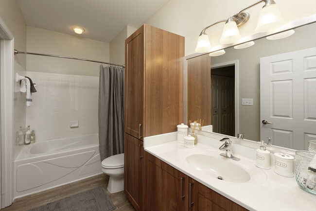 Hazelnut Finish Package bath with white countertop and hard surface flooring - Avalon at Arlington Square