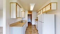 Located at 1813 Drexler Ln NE in Keizer, Oregon, this single-floor, 3-bedroom, 1-bathroom home offers a practical and well-organized layout. The galley-style kitchen is efficiently designed with ample white cabinetry trimmed in warm wood tones, granite-look countertops, tile flooring, and white appliances including a range, dishwasher, and refrigerator. A skylight fixture brightens the kitchen, which opens toward a dining area featuring a ceiling fan and a window overlooking the neighborhood. Each of the three bedrooms is carpeted and bathed in natural light from large windows framing views of surrounding greenery. The spacious primary bedroom includes a sliding glass door that leads to a private wooden deck, offering pleasant outdoor views. Additional bedrooms provide closet storage, including sliding-door closets. The full bathroom is appointed with tile flooring matching the kitchen, a vanity with storage, and a full tub-shower combination. A hallway connects the rooms efficiently throughout the home. With a clean, neutral palette and consistent finishes throughout, this home presents a comfortable and move-in ready living environment in a residential Keizer neighborhood.