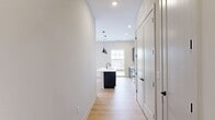 This contemporary 850 square foot apartment in Livingston, NJ, offers a harmonious blend of style and functionality. The open-concept design maximizes space, creating a seamless flow between the living areas. The heart of the home is a modern kitchen, showcasing dark cabinetry, stainless steel appliances, and a convenient island, perfect for casual dining or entertaining.

Large windows dominate the living spaces, flooding the rooms with natural light and providing picturesque views of the surrounding area. The warm-toned hardwood floors contrast beautifully with the neutral walls, creating a welcoming ambiance throughout.

The bedroom, measuring 140 square feet, features a built-in closet for ample storage. The bathroom boasts a clean, minimalist design with a floating vanity, large mirror, and a shower-tub combination. 

The apartment's thoughtful layout incorporates a dedicated living room area, ideal for relaxation or hosting guests. The overall design aesthetic is sleek and modern, with attention to detail evident in the fixtures and finishes. This single-floor residence offers a perfect balance of comfort and style for contemporary urban living.