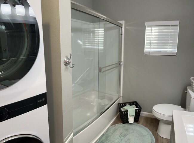 Bathroom with shower along with a washer and dryer - 20576 Sunset Ln