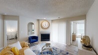 This well-appointed three-bedroom, four-bathroom residence in Lexington, Kentucky offers a thoughtfully designed single-floor layout. The open living area features wood-look flooring, a textured ceiling, and a tile-surround fireplace as a central focal point, complemented by a sliding glass door that welcomes natural light. The layout flows seamlessly into a galley-style kitchen outfitted with granite countertops, gray shaker cabinetry, stainless steel appliances, and a double-basin sink — a functional and attractive space for everyday cooking. The primary bedroom is a comfortable retreat with plush carpeting, a ceiling fan, and a connected en-suite bathroom. Additional bedrooms also feature ceiling fans and natural light from well-positioned windows, each served by its own access to the four full bathrooms. The bathrooms are finished with gray vanities, white quartz countertops, wood-look tile flooring, and tiled tub-shower combinations with decorative accent tile. A dedicated in-unit laundry room adds everyday convenience. Three closets and a utility room provide ample storage throughout. This residence combines practical functionality with clean, modern finishes in a well-organized floor plan.