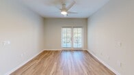 Located at 211 River Landing Drive in Charleston, SC, this 2-bedroom, 2-bathroom residence offers a well-designed single-floor layout with a clean, contemporary aesthetic. Light-toned hardwood flooring flows seamlessly throughout, creating a cohesive and bright atmosphere across every room.

The kitchen is a standout feature, boasting crisp white shaker cabinetry extending to the ceiling for ample storage, granite countertops with a subtle speckled pattern, a central island with pendant lighting, and a full suite of stainless steel appliances including a refrigerator with ice maker, electric range, built-in microwave, and dishwasher. The kitchen connects openly to the living area, promoting an easy flow for everyday living.

Both bedrooms are generously proportioned, each equipped with ceiling fans and dedicated walk-in closets outfitted with wire shelving systems that maximize storage capacity. The primary bedroom is a comfortable retreat with its own well-appointed en-suite bathroom featuring a glass-enclosed walk-in shower and a granite-topped vanity. The second bathroom offers a tiled tub-shower combination alongside a matching granite vanity. A connecting hallway ties the layout together efficiently, completing this thoughtfully designed Charleston residence.
