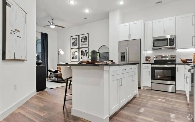 Apartment Interior with White Cabinets and Combined Living Space - The Elm at River Park