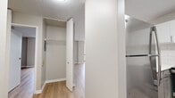This single-floor unit at 949 Lake St in Oak Park, Illinois, offers a thoughtfully updated interior with a clean, modern aesthetic throughout. Light-toned hardwood-style flooring runs continuously across the space, complementing the neutral gray walls and white trim to create a bright, cohesive feel.

The open living area is a standout feature, anchored by expansive floor-to-ceiling windows that frame sweeping views of the surrounding Oak Park neighborhood and fill the room with abundant natural light. The layout flows naturally from the living area toward the kitchen, which is accessible via an open pass-through or direct entry. The kitchen has been fully updated with two-tone cabinetry—white upper cabinets and gray lower cabinets—paired with a white quartz countertop, subway tile backsplash, stainless steel refrigerator, range, and dishwasher, as well as a sleek utility sink with a modern gooseneck faucet.

Additional features include a dedicated closet with a built-in rod and shelving system, providing organized storage. The textured ceiling and clean wall surfaces throughout contribute to the unit's well-maintained, move-in-ready condition. The overall ambiance is contemporary and functional, well-suited for everyday living.