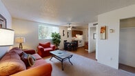 Located at 6160 E Bellevue St in Tucson, Arizona, this single-floor residence offers a practical and comfortable layout with well-defined living spaces throughout. The entryway opens into a carpeted living room, which is generously sized and bathed in natural light from a large window fitted with vertical blinds. A ceiling fan overhead provides year-round comfort, and the space flows seamlessly into the dining area, which features hardwood-style flooring and a window that further brightens the interior. The galley-style kitchen is efficiently designed, featuring warm wood cabinetry, a full suite of white appliances including an electric range and refrigerator, a double sink with ample counter space, and an under-cabinet range hood. The bedroom is a calm, carpeted retreat with a large sliding-door closet offering plentiful storage and a window that invites natural light. The bathroom includes a wood-vanity with a granite-style countertop, an integrated sink, a wide mirror, and a separate toilet and shower area. Throughout the residence, textured ceilings, neutral walls, and a mix of carpet and hardwood-style flooring create a cohesive and welcoming ambiance well-suited to everyday living in Tucson.