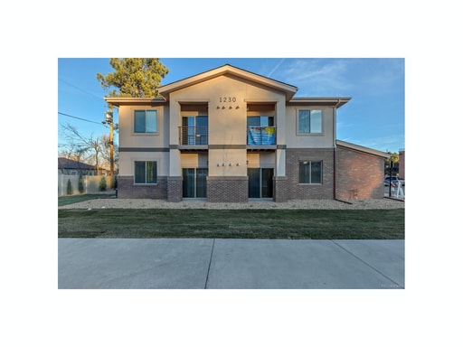 Inviting two-story apartment building with a modern design and well-maintained landscape. - Two Creeks Crossing Apartments