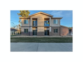 Inviting two-story apartment building with a modern design and well-maintained landscape. - Two Creeks Crossing Apartments