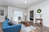 Located in Magna, Utah, this single-story home offers four bedrooms and two bathrooms within a smart, functional layout. The open-concept living, dining, and kitchen area forms the heart of the home, featuring durable wood-look flooring, neutral tones, and a textured ceiling throughout. Ceiling fans provide comfort in both the living and dining areas, while a sliding glass door floods the space with natural light and provides outdoor access.

The kitchen is well-appointed with rich dark cabinetry, granite-style countertops, black appliances including a range and built-in microwave, and a U-shaped layout that maximizes workspace and storage. The adjacent dining area comfortably accommodates a full table and chairs beneath a ceiling fan.

The bedrooms are carpeted and bright, each featuring windows with blinds and generous wall space. The primary bedroom offers a comfortable footprint with natural light. The two bathrooms are finished with wood-look flooring, dark wood vanities, granite-style countertops, and a shower-tub combination. A dedicated laundry room includes side-by-side washer and dryer units, built-in wire shelving, and additional storage space, adding everyday convenience to this well-designed home.