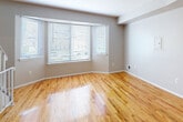Located at 528B Seaview Ave in Staten Island, NY, this two-story home offers a well-organized layout spread across two floors, accommodating four bedrooms and two full bathrooms. The ground floor hosts the combined kitchen and living area alongside a bathroom and hallway, while the upper floor contains the majority of the bedrooms and a second bathroom.

Warm, polished hardwood floors run throughout the living spaces and bedrooms, lending continuity and a bright, welcoming ambiance to the interior. The living room receives natural light through large windows fitted with blinds, creating an open and airy feel. The kitchen is thoughtfully updated, featuring white shaker cabinetry, dark granite countertops, a gray glass tile backsplash, and a full suite of stainless steel appliances, including a gas range, microwave, dishwasher, and refrigerator.

The bedrooms feature vaulted or angled ceilings with ceiling fans, enhancing the sense of space. The primary bedroom includes dual closets for ample storage. The bathrooms contrast in style: one showcases dark large-format tile, a glass-enclosed shower, and modern black fixtures, while the second features a white vanity with a clean quartz countertop and a textured tile accent wall. Hallways connect the rooms efficiently across both levels.