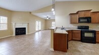 This single-floor residence on Stonewater Place in Jackson, Tennessee offers a well-organized layout across a generously sized footprint. The open-concept living area serves as the heart of the home, featuring a tile floor in a warm earth tone, a classic white-mantled fireplace, and multiple windows that bring in natural light. A ceiling fan enhances comfort, while French doors provide additional access and brightness.

The kitchen flows seamlessly into the living and dining space, equipped with rich wood cabinetry, granite countertops, a peninsula with pendant lighting overhead, and a stainless steel sink — making it both functional and visually connected to the main living area.

The spacious primary bedroom is carpeted and includes a ceiling fan and natural light from a window with outdoor views. A closet with double doors and wire shelving provides practical storage. The second bedroom features tile flooring and its own window.

Both bathrooms are finished with tile floors and light gray walls. The primary bath includes a soaking tub and direct access to the walk-in closet area. A dedicated laundry room with washer and dryer hookups and overhead shelving adds everyday convenience throughout this well-appointed home.