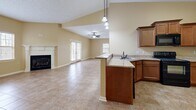 This single-floor residence on Stonewater Place in Jackson, Tennessee offers a well-organized layout across a generously sized footprint. The open-concept living area serves as the heart of the home, featuring a tile floor in a warm earth tone, a classic white-mantled fireplace, and multiple windows that bring in natural light. A ceiling fan enhances comfort, while French doors provide additional access and brightness.

The kitchen flows seamlessly into the living and dining space, equipped with rich wood cabinetry, granite countertops, a peninsula with pendant lighting overhead, and a stainless steel sink — making it both functional and visually connected to the main living area.

The spacious primary bedroom is carpeted and includes a ceiling fan and natural light from a window with outdoor views. A closet with double doors and wire shelving provides practical storage. The second bedroom features tile flooring and its own window.

Both bathrooms are finished with tile floors and light gray walls. The primary bath includes a soaking tub and direct access to the walk-in closet area. A dedicated laundry room with washer and dryer hookups and overhead shelving adds everyday convenience throughout this well-appointed home.